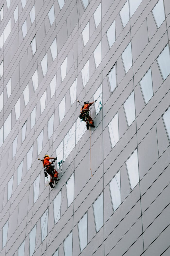 services-img High-rise facade window cleaning on a modern skyscraper for urban maintenance.