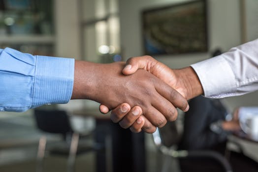 pexels photo 955395 955395 1 Close-up of two men's handshake symbolizing agreement in an office.